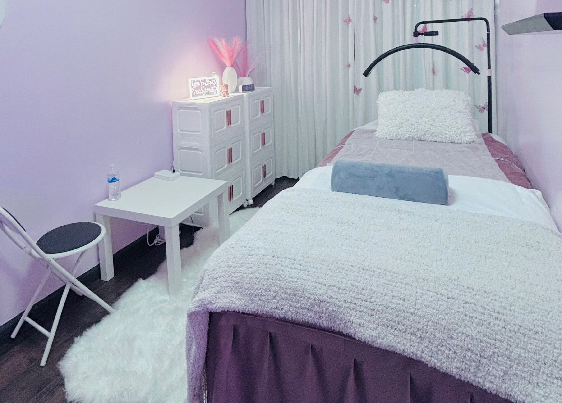 Relaxing treatment room at Lash and Brows by Suzet in Missouri City, Texas, US, featuring a plush bed and calming decor.