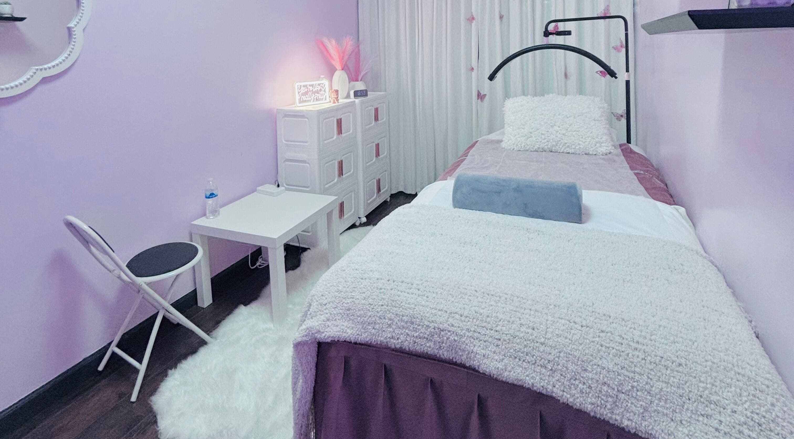 Relaxing treatment room at Lash and Brows by Suzet in Missouri City, Texas, US, featuring a plush bed and calming decor.