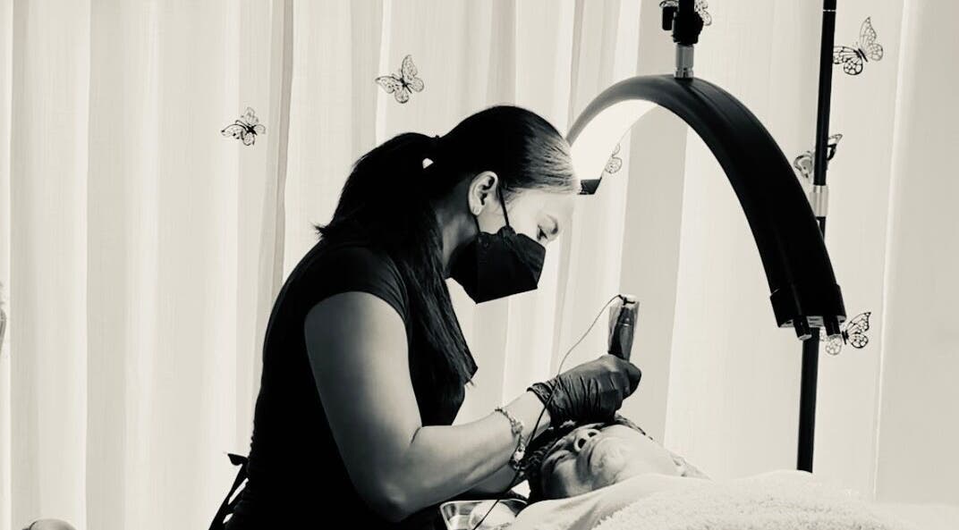 Technician at Lash and Brows by Suzet in Missouri City, Texas, providing care under soft lighting.