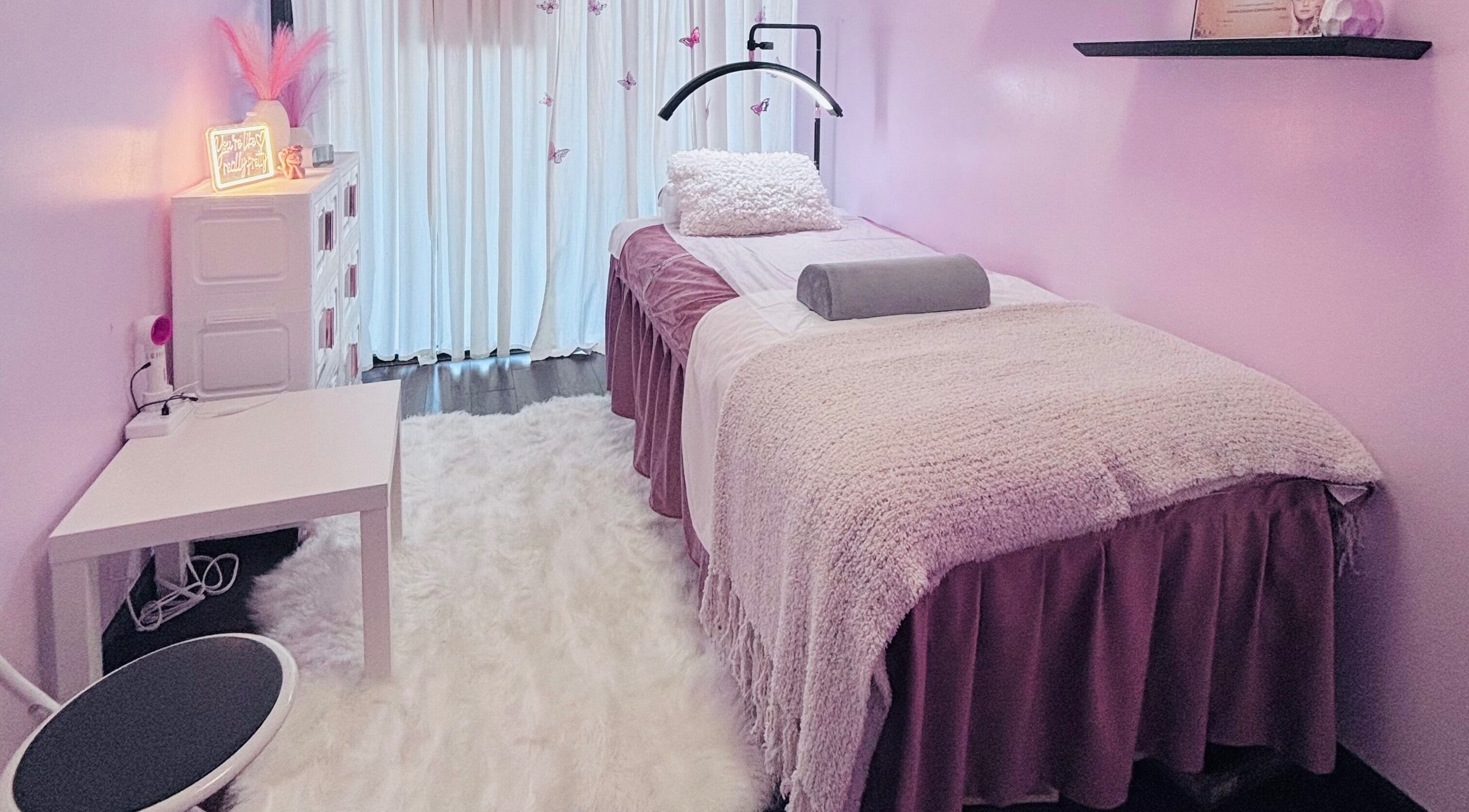 Inviting treatment room at Lash and Brows by Suzet, Missouri City, Texas, US, featuring soft decor and a plush bed.