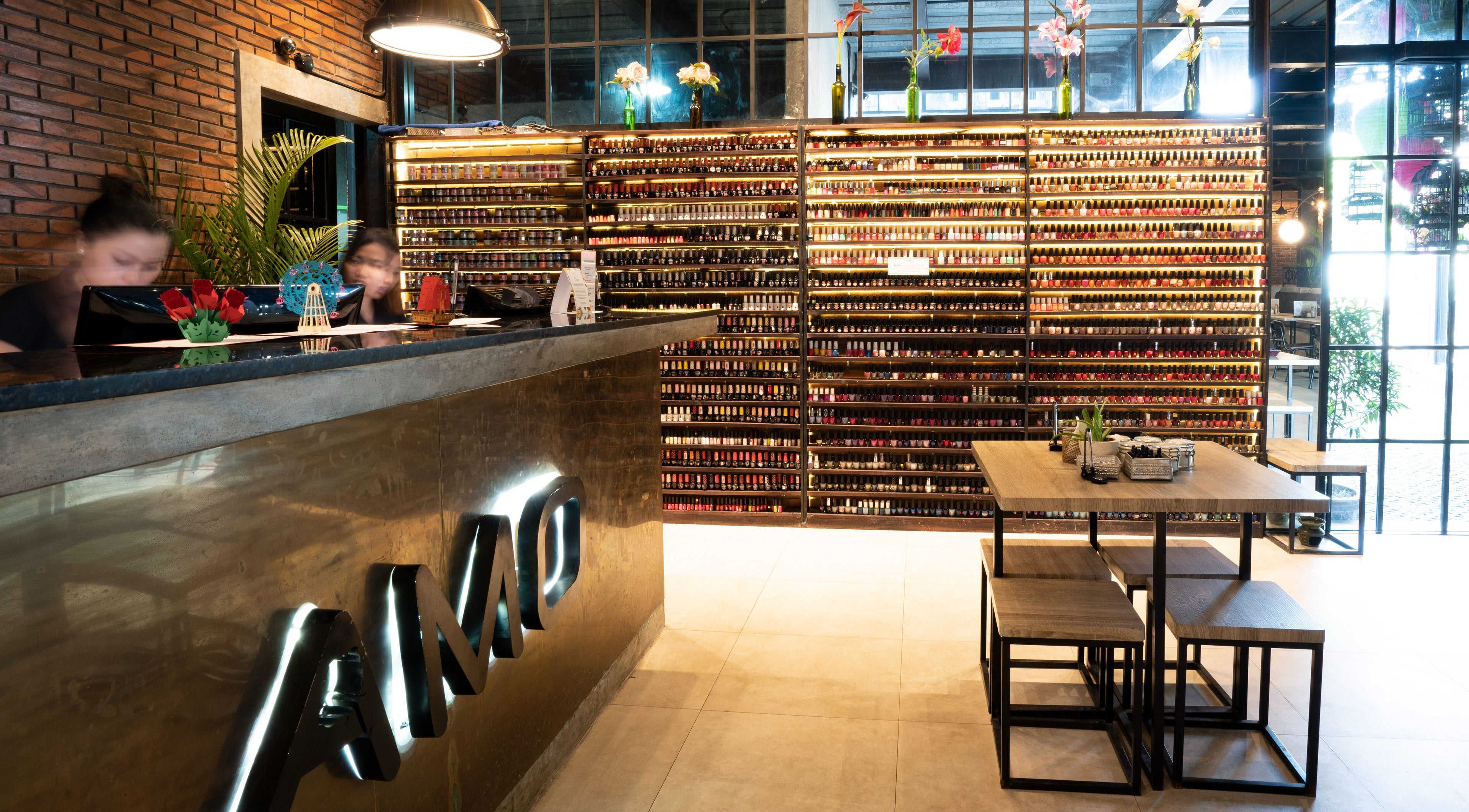 Luxurious interior at Amo Spa reception in Bali, Bali, ID with nail polish display and seating area.