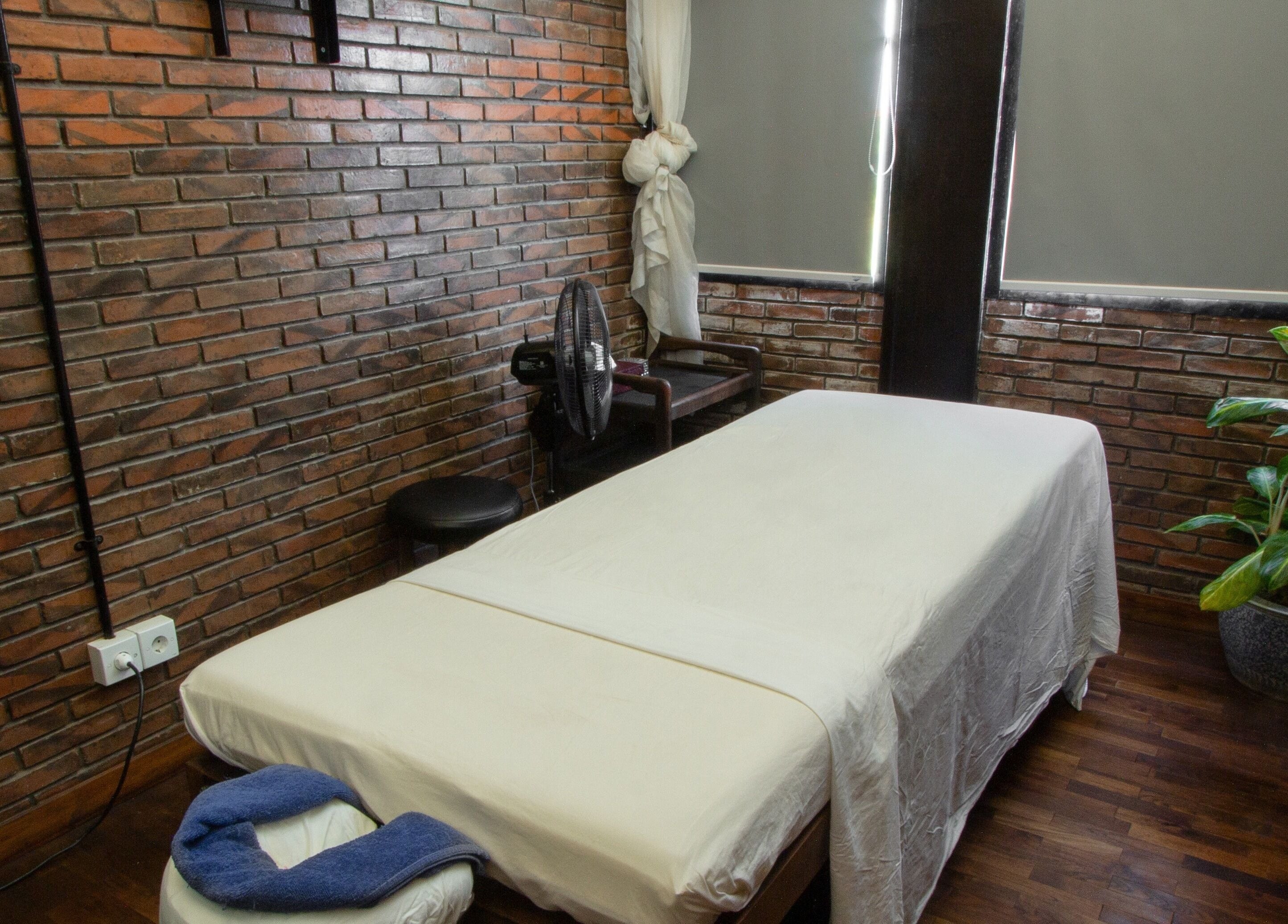 Serene massage room at Amo Spa, Bali, Bali, ID with a cozy bed and soothing ambiance.