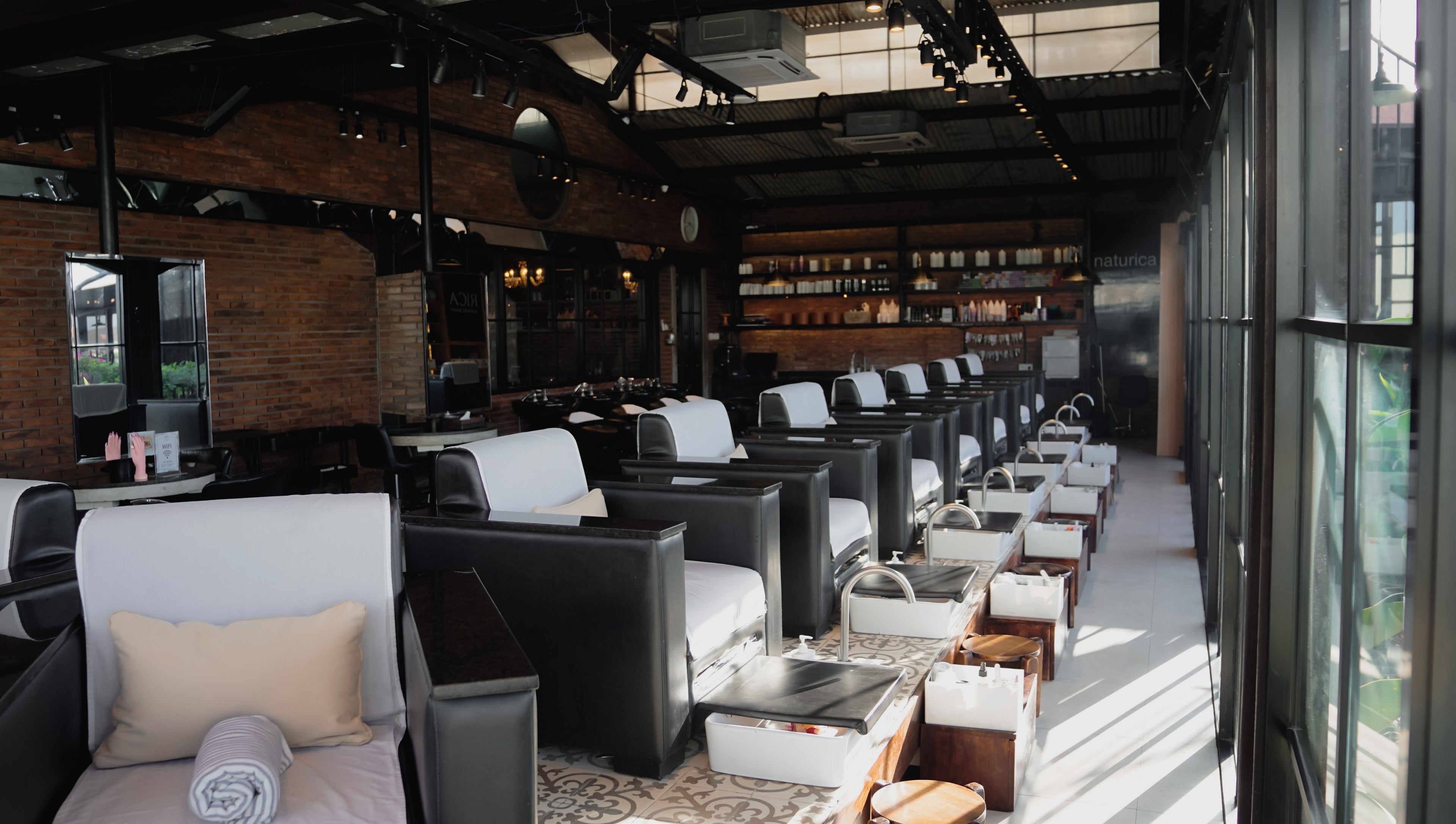 Luxurious seating area inside Amo Spa, Bali, Bali, ID with plush chairs and stylish decor.