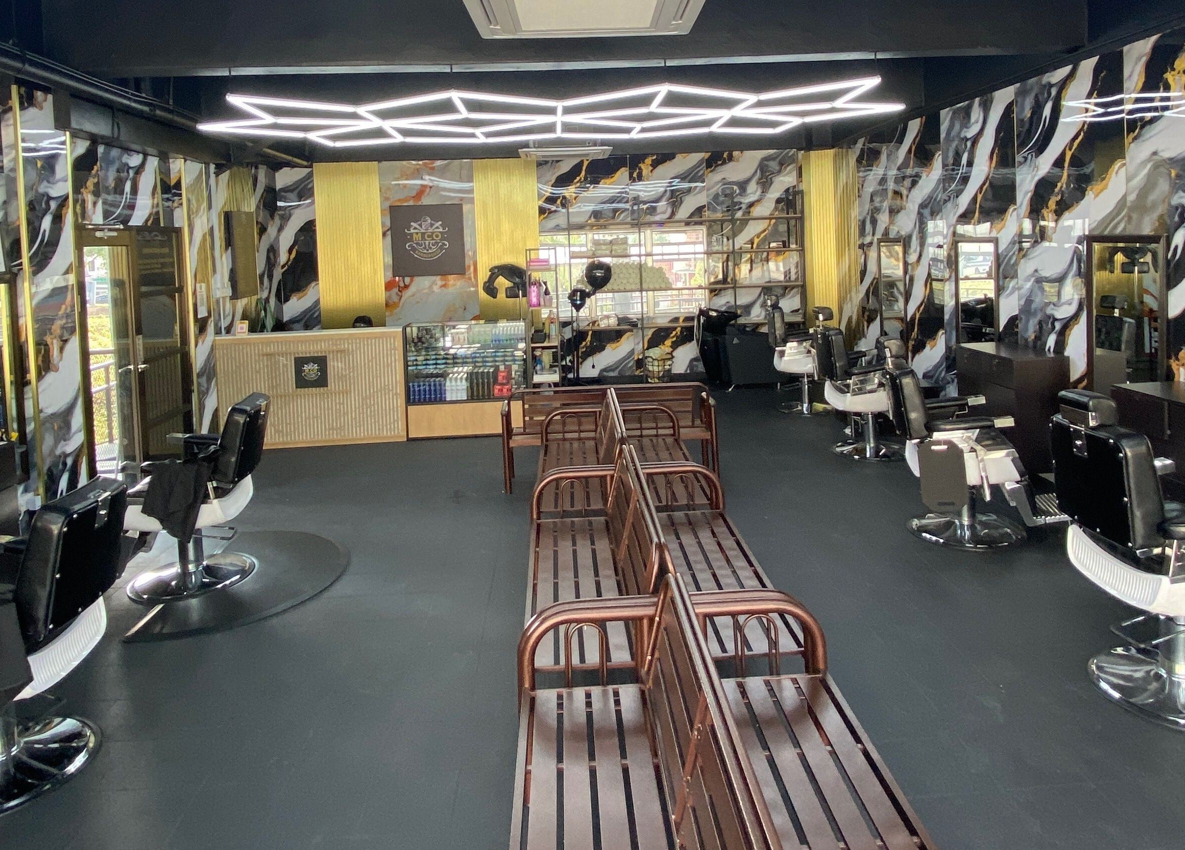 Modern interior of MCo Barbershop Hq in Shah Alam, Selangor with chic decor and elegant barber chairs.