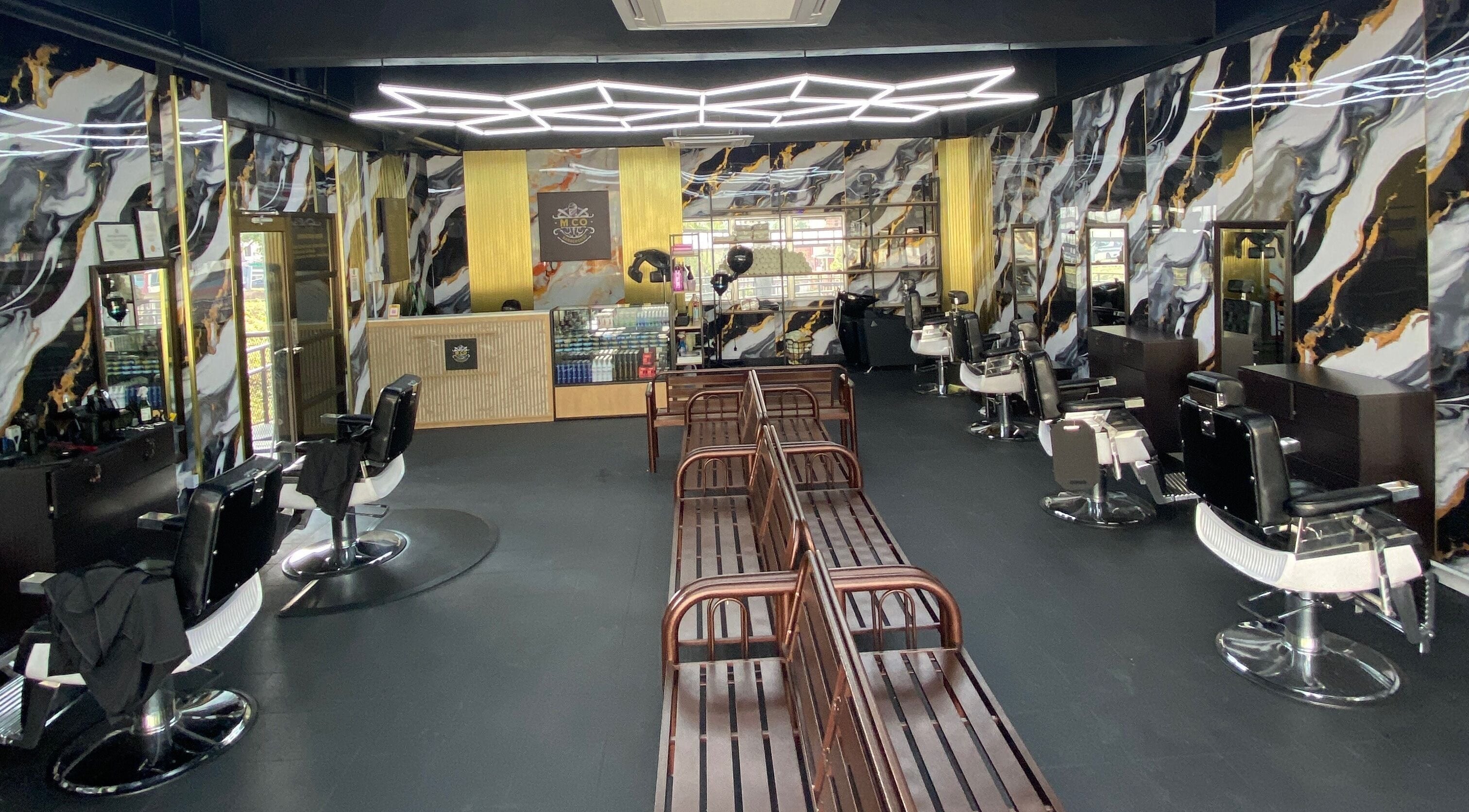 Modern interior of MCo Barbershop Hq in Shah Alam, Selangor with chic decor and elegant barber chairs.