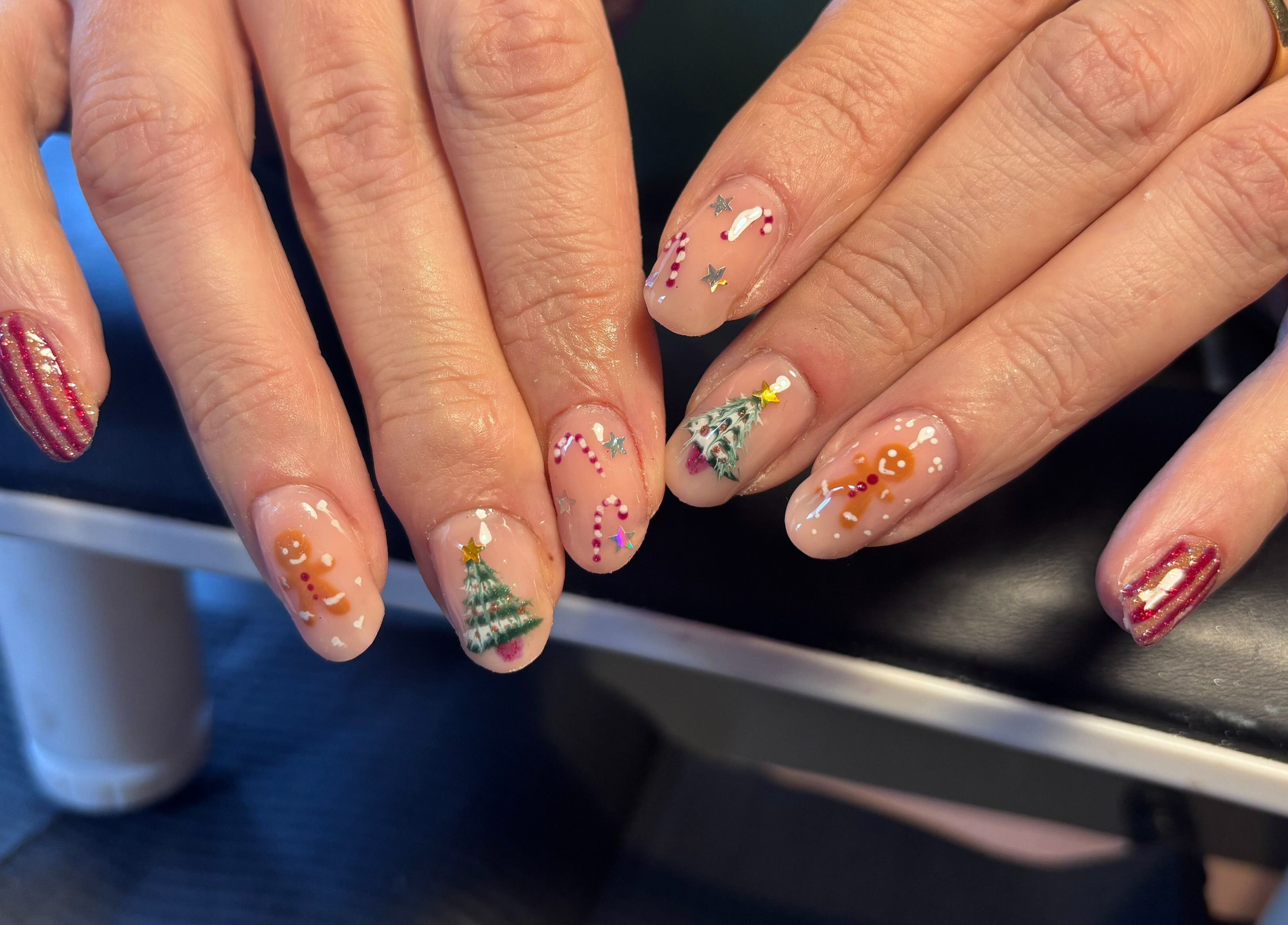 Festive nail art at Black Cat Nails, Long Lawford, England, GB. Features Christmas-themed designs on manicured nails.