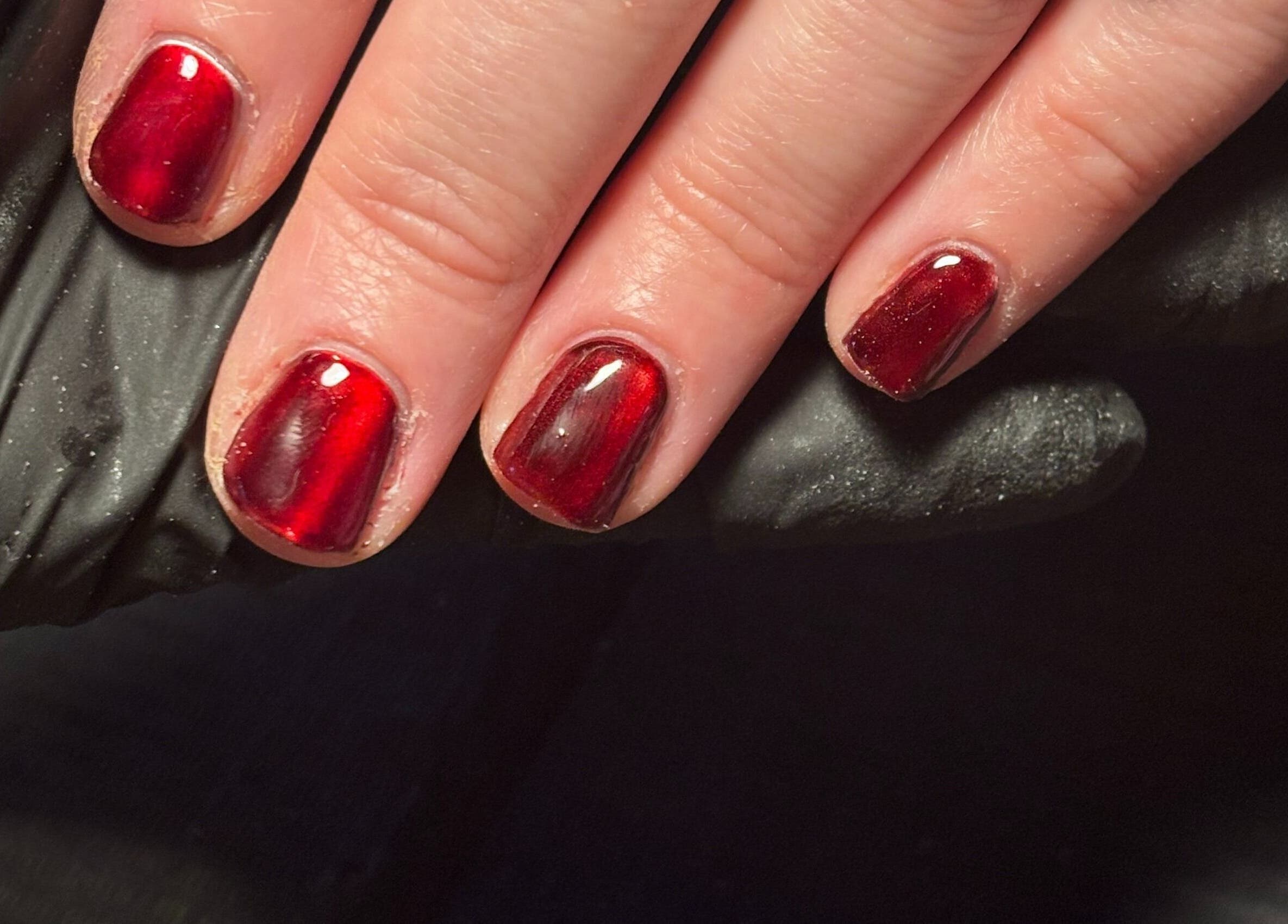 Glossy crimson nails at Black Cat Nails, Long Lawford, England, GB offer elegance and sophistication.
