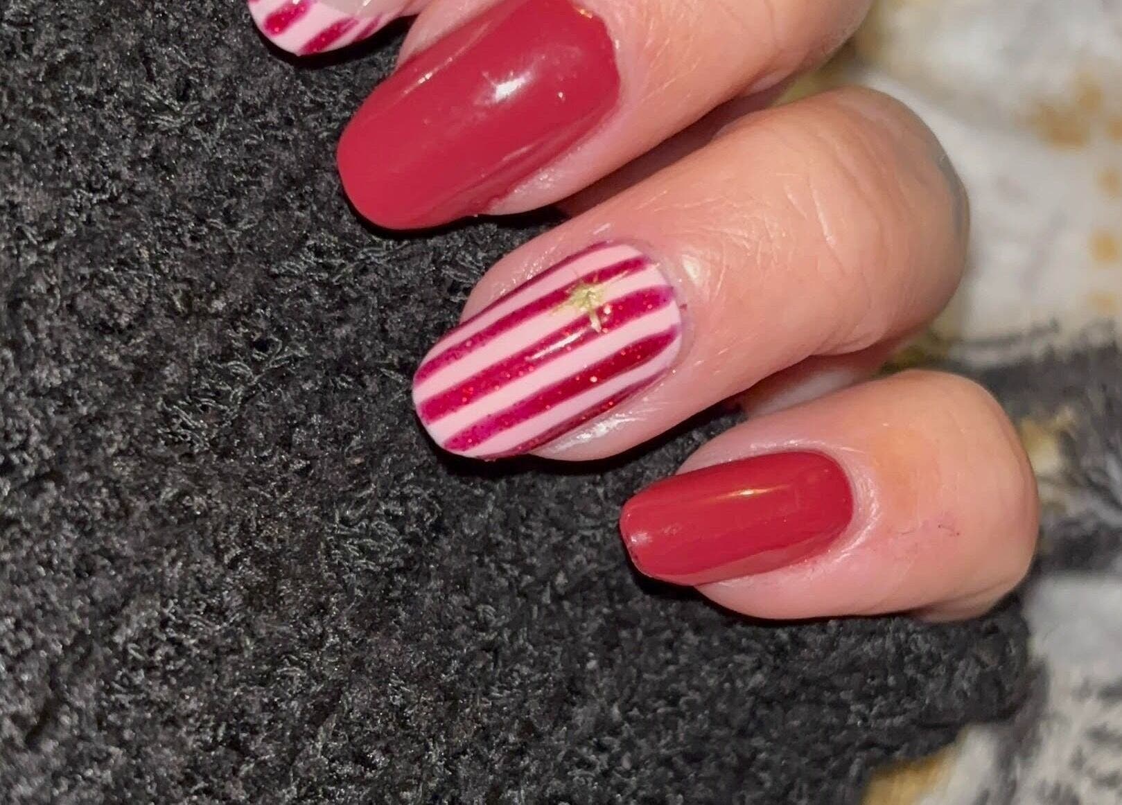 Red and striped nail art at Black Cat Nails, Long Lawford, England, GB. Stylish and chic design.