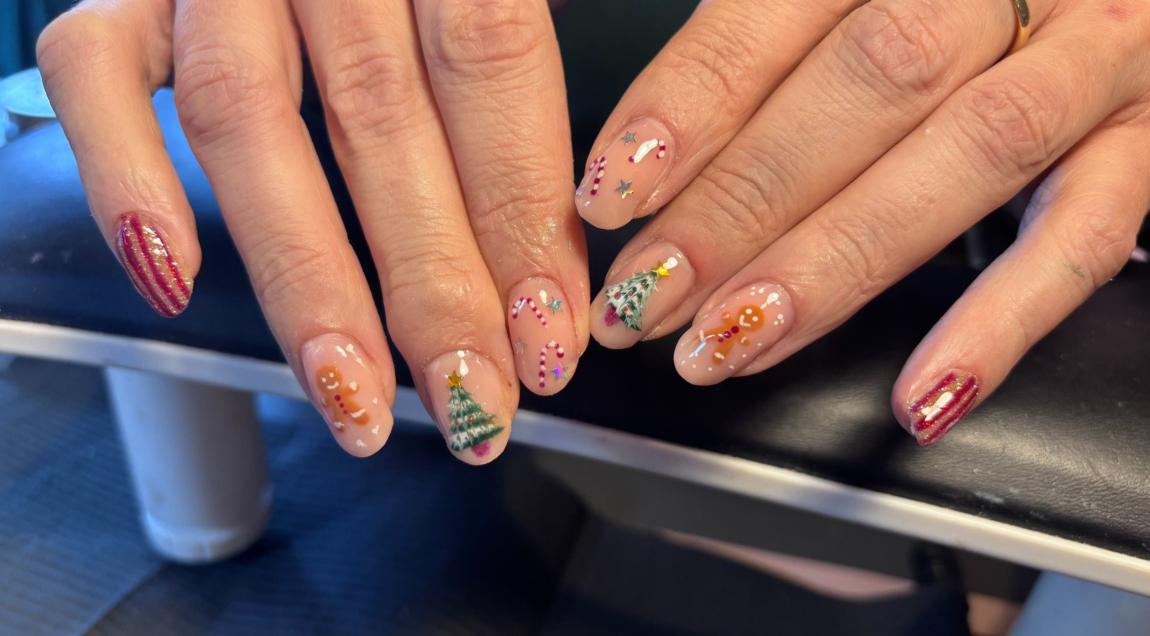 Festive themed nail art at Black Cat Nails, Long Lawford, England, GB. Features Christmas trees and candy canes.