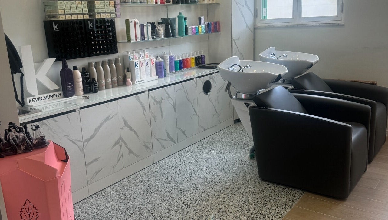 Luxi Hairdressing shampoo station with sleek chairs and products in Tas-sliema, MT.
