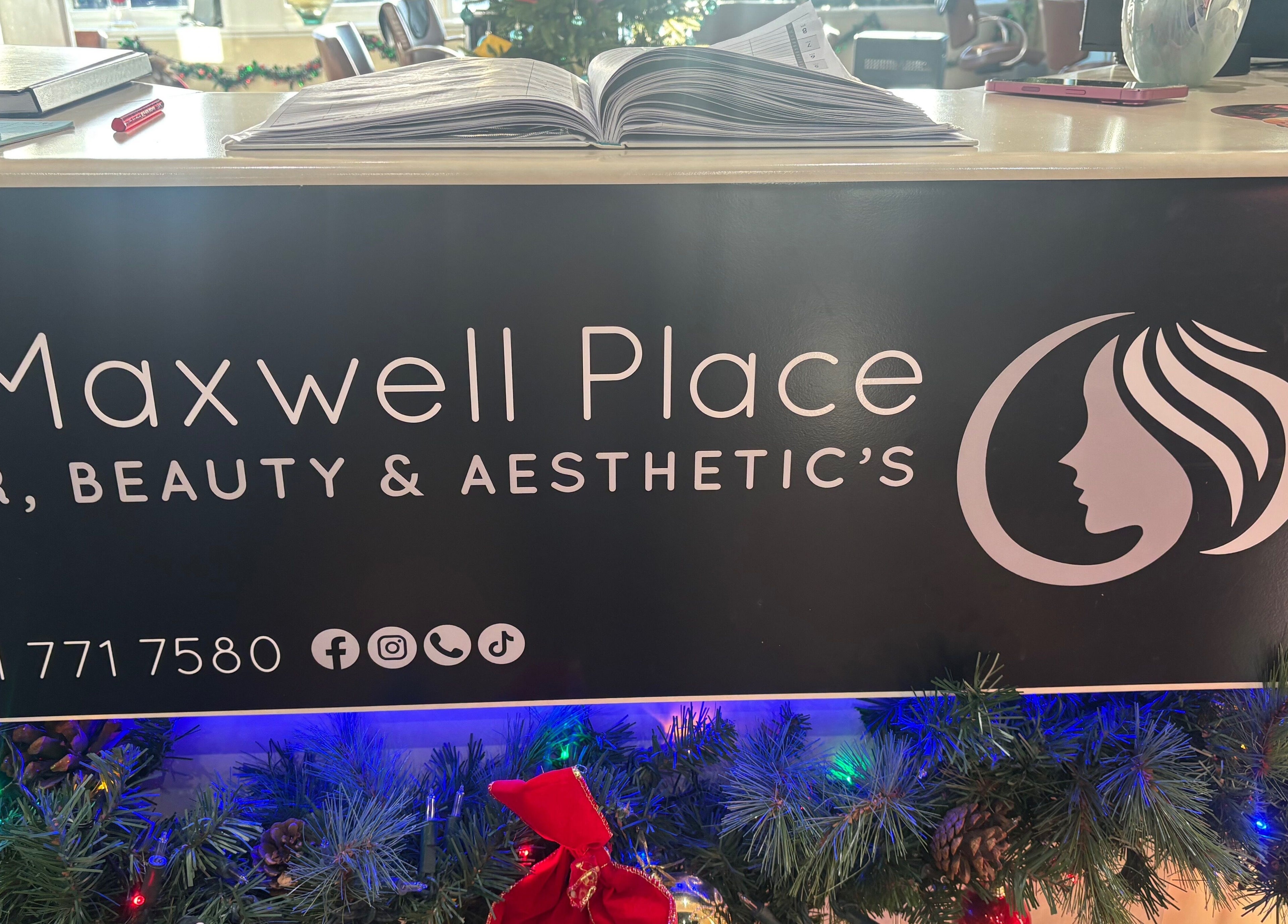 Reception desk at Bee Beautiful Extensions By Linzi in Glasgow, Scotland, GB decorated for the holidays.