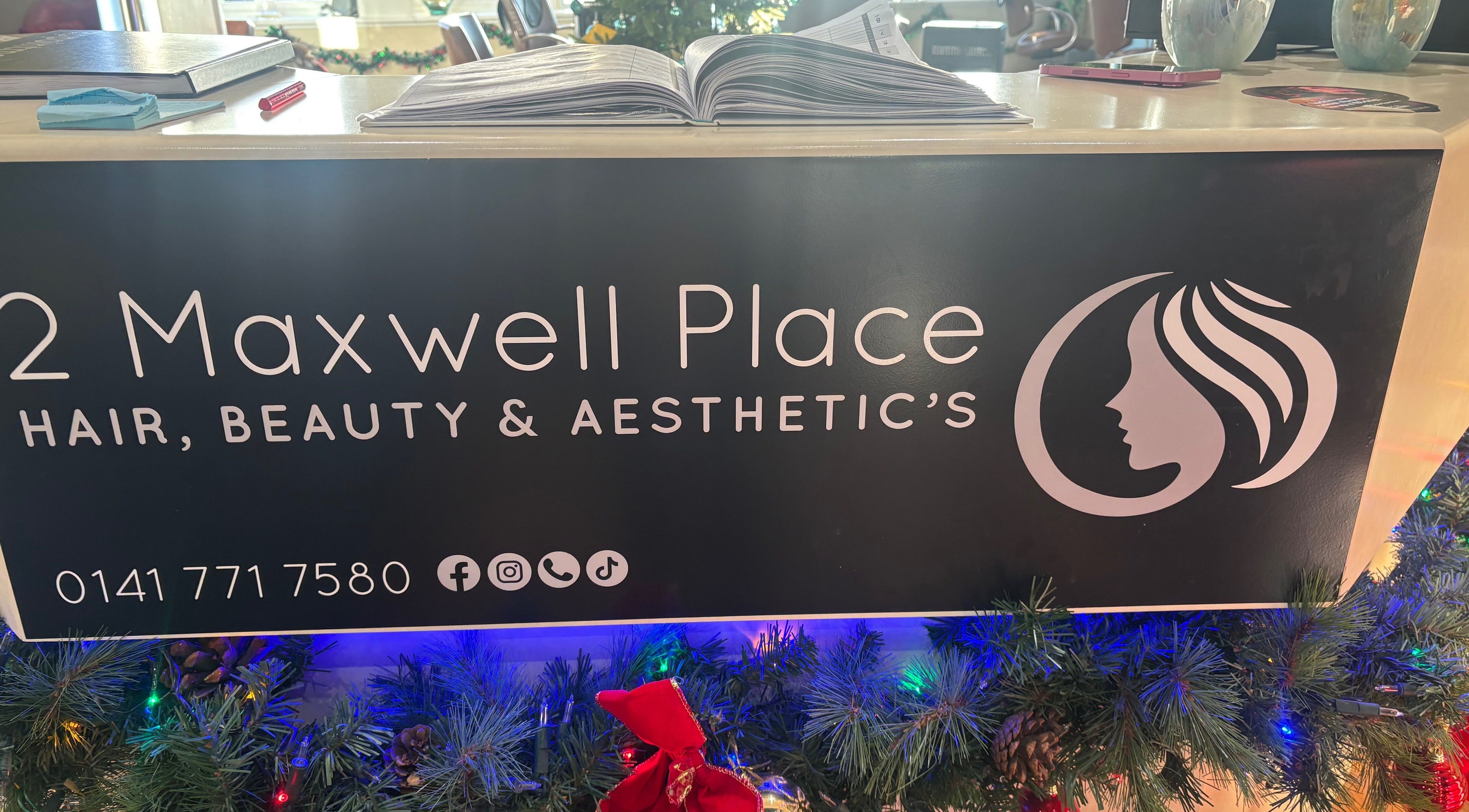 Reception desk at Bee Beautiful Extensions By Linzi in Glasgow, Scotland, GB decorated for the holidays.