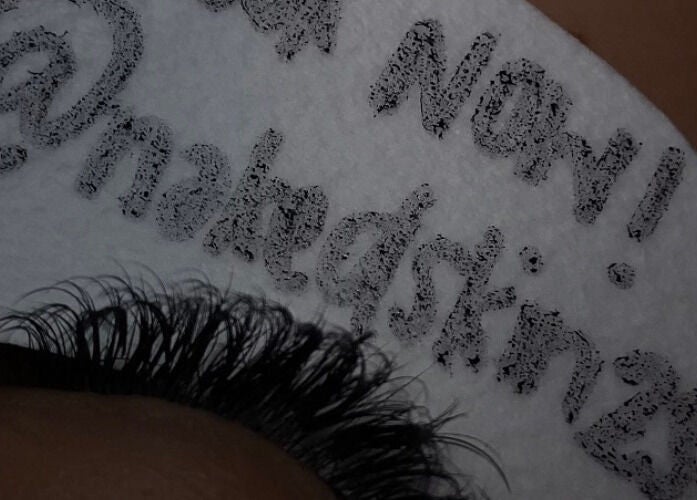 NĀSKIN promotes lash extensions in Cape Town, Western Cape, ZA with unique branding in this detailed close-up.