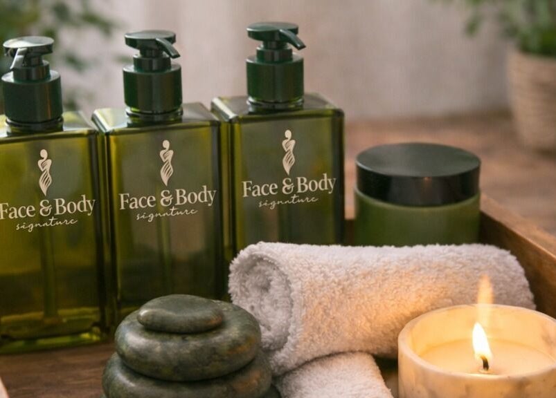 Face & Body Signature - Home Service spa setup with oils in Dubai, Dubai, AE. Includes candles, stones, and towels.