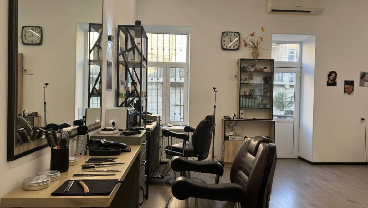Interior view of Barbershop by Z, Bakı, AZ. Features salon chairs, mirrors, and grooming tools in a well-lit space.