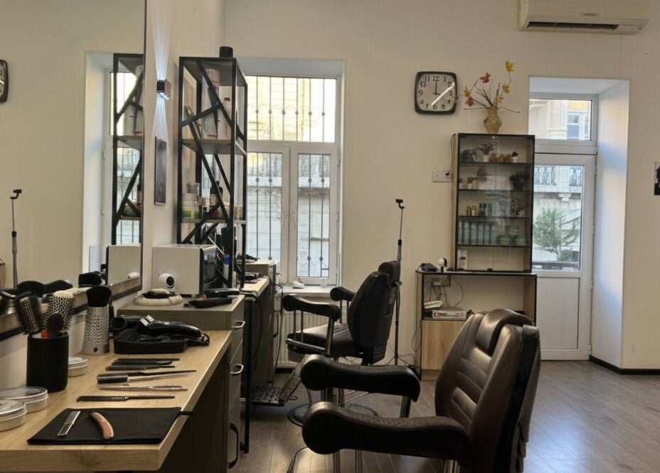 Interior view of Barbershop by Z, Bakı, AZ. Features salon chairs, mirrors, and grooming tools in a well-lit space.
