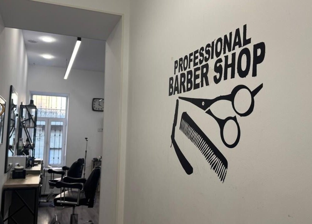 Interior view of Barbershop by Z in Bakı, AZ, featuring stylish chairs and wall art.