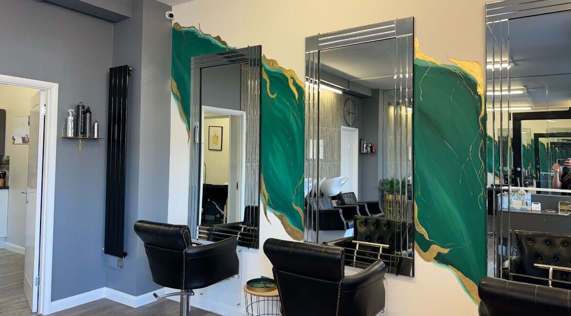 Modern salon interior at Makeupbyparislauren, Bristol, England, GB with stylish chairs and vibrant decor.