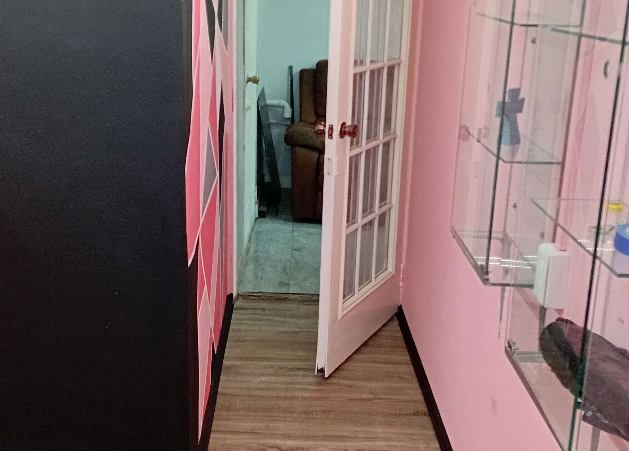 Chic hallway at Anastasia's Beauty Co™ in Esmeralda, Caroni, TT, featuring modern decor and glass shelves.