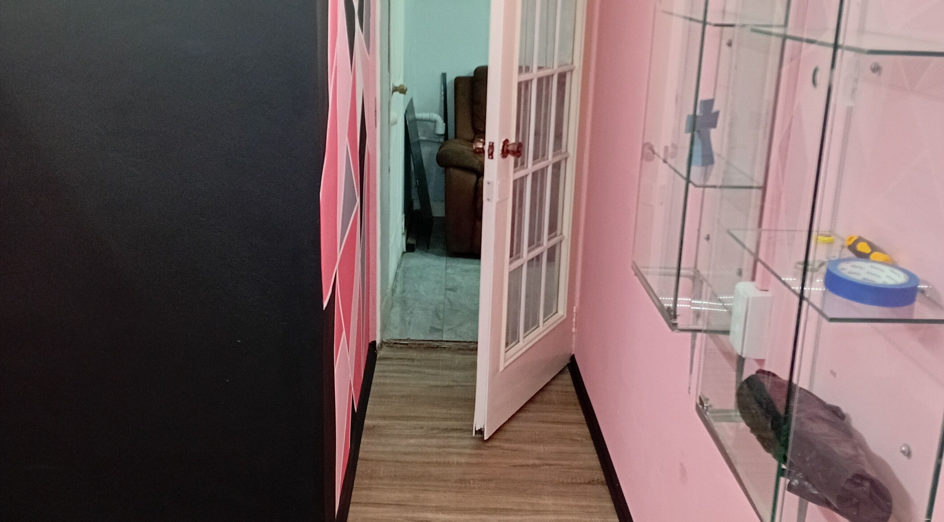 Chic hallway at Anastasia's Beauty Co™ in Esmeralda, Caroni, TT, featuring modern decor and glass shelves.