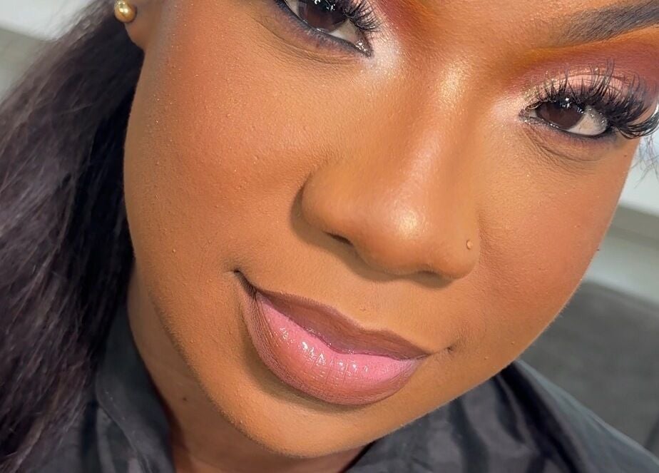 Woman with radiant makeup at Beauty by Lys, TT, showcasing flawless beauty services.