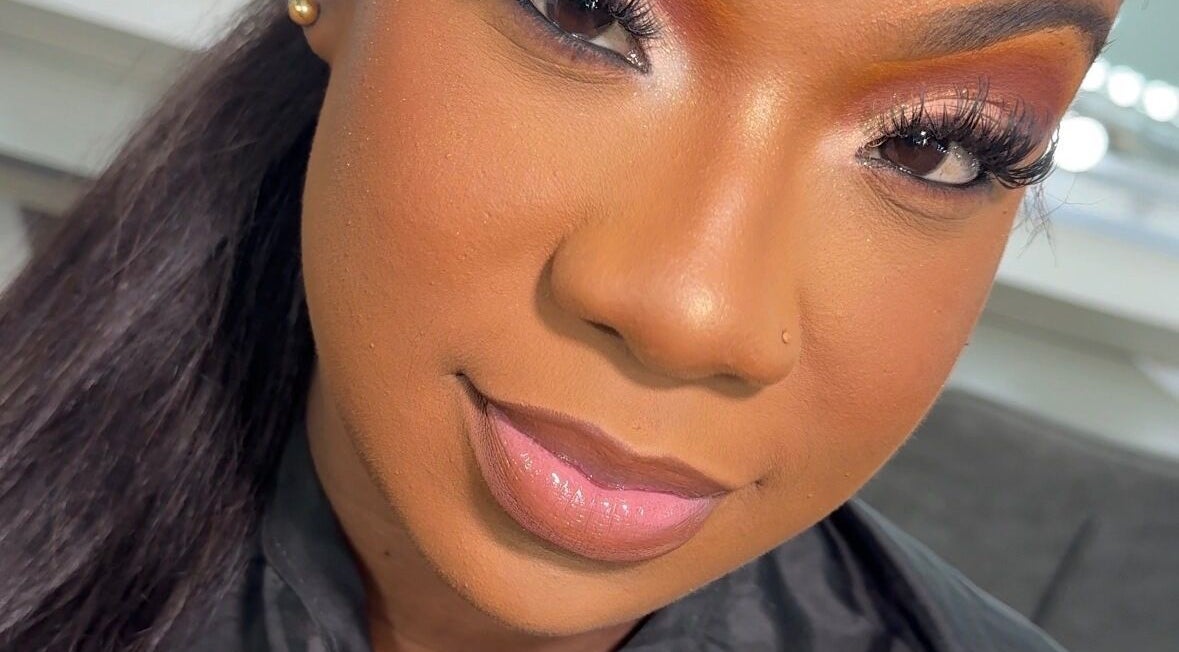 Woman with radiant makeup at Beauty by Lys, TT, showcasing flawless beauty services.