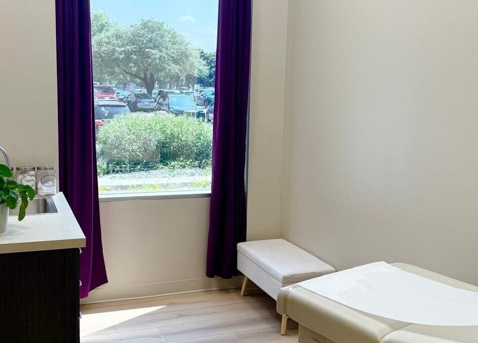 Calm treatment room at Natural Hormone Replacement Center, Dallas, Texas, US with a window view and potted plant.