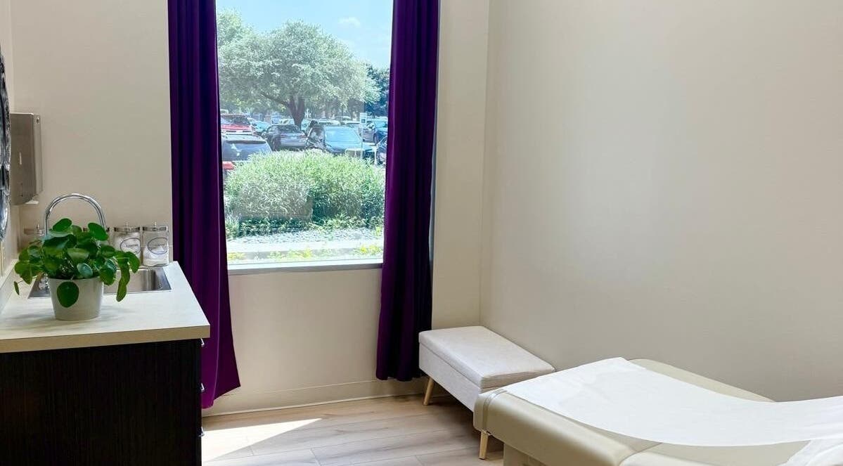 Calm treatment room at Natural Hormone Replacement Center, Dallas, Texas, US with a window view and potted plant.