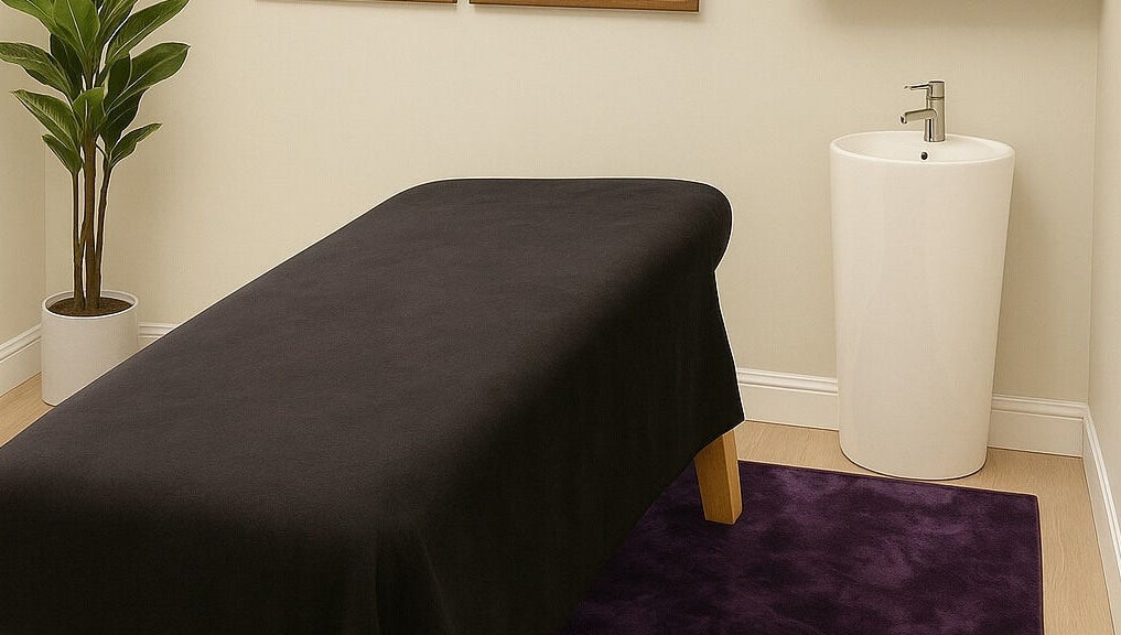 Massage room with black table and elegant decor at Apapacho Studio, Clearwater, Florida, US.