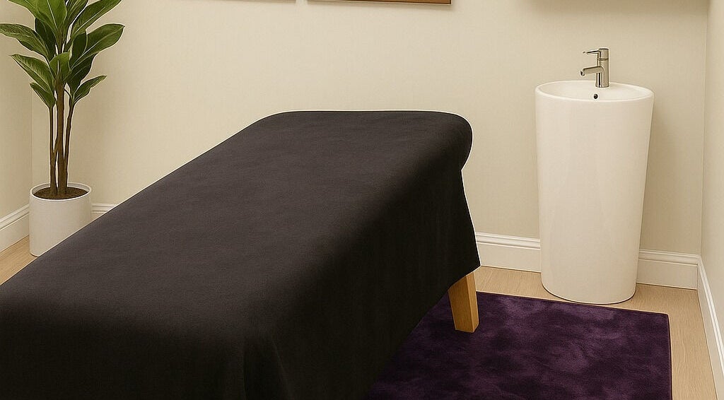 Massage room with black table and elegant decor at Apapacho Studio, Clearwater, Florida, US.