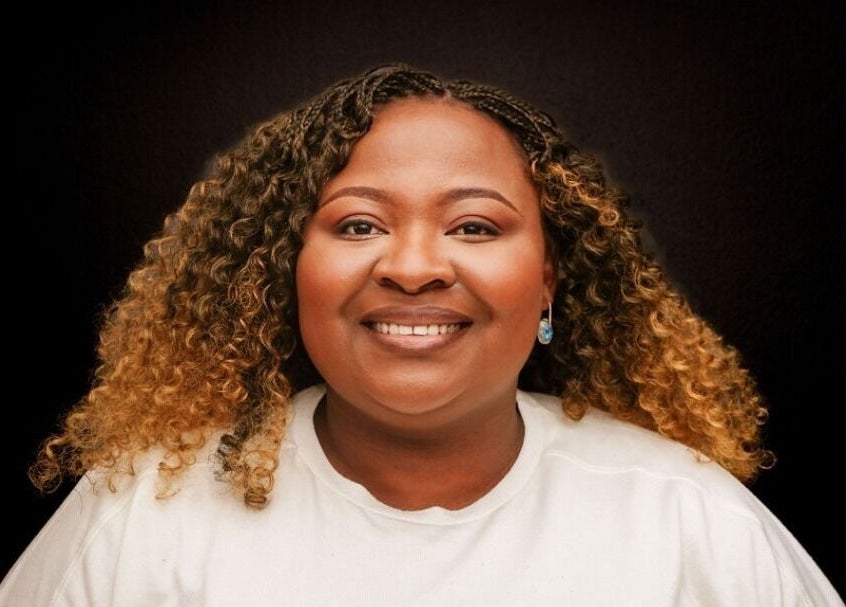 Smiling woman with styled curls at TKs lash & brow studio, Sandton, Gauteng, ZA.