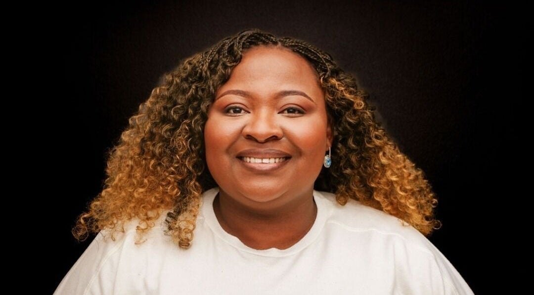 Smiling woman with styled curls at TKs lash & brow studio, Sandton, Gauteng, ZA.