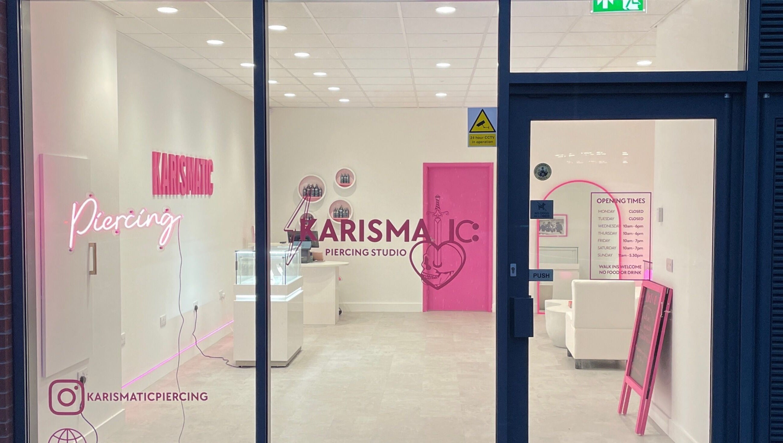 Karismatic Studio in Derby, England, GB viewed from outside, showcasing sleek interior and neon signage.
