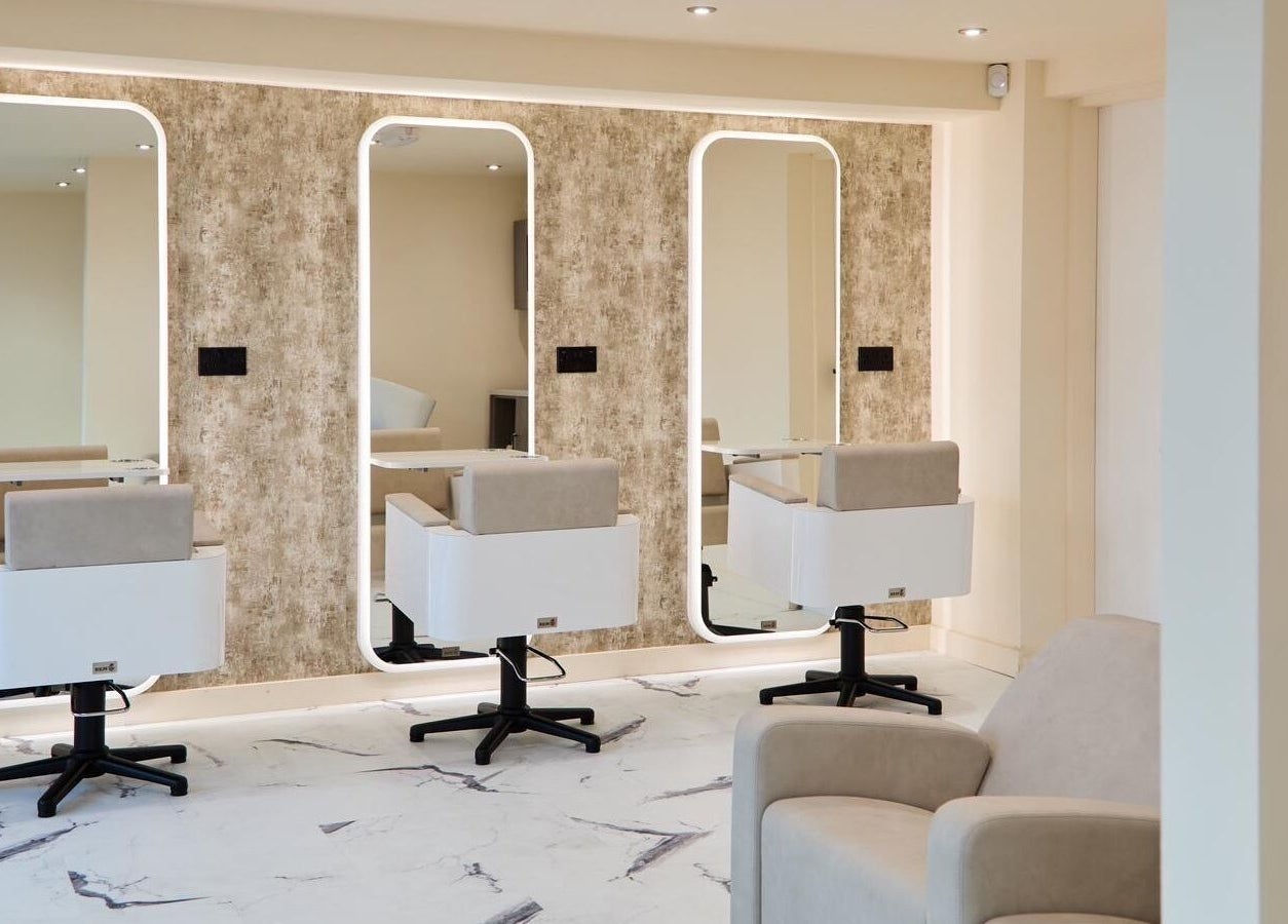 Chic salon interior at S.Rose By Linda, Ramsbottom, England, GB with stylish chairs and illuminated mirrors.