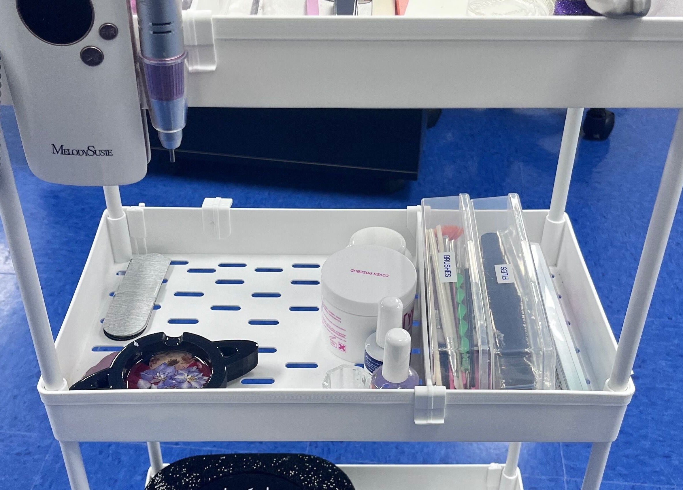 Nail tool station at NailsoDivine in Orlando, Florida, US, featuring polishes, files, and brushes.