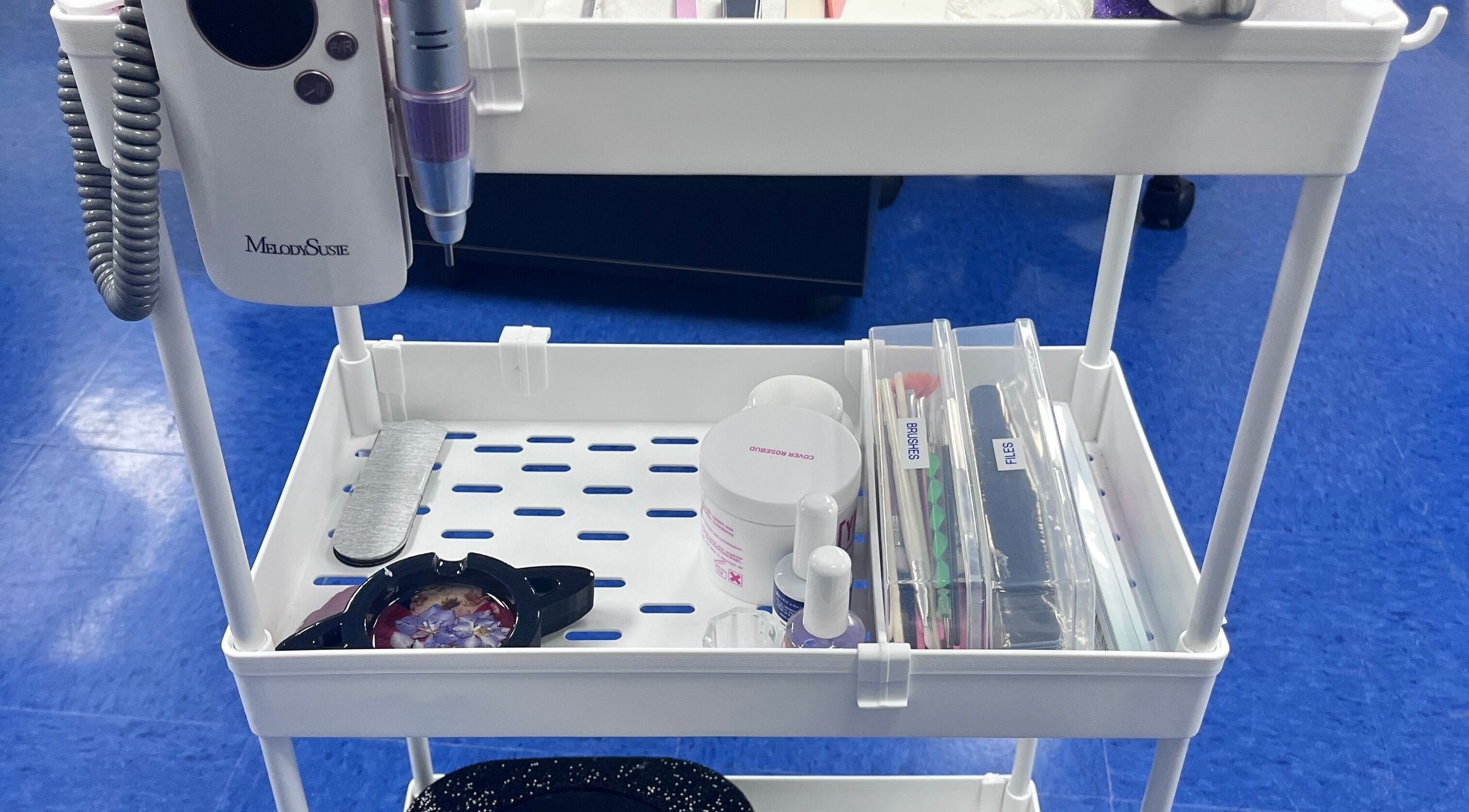 Nail tool station at NailsoDivine in Orlando, Florida, US, featuring polishes, files, and brushes.