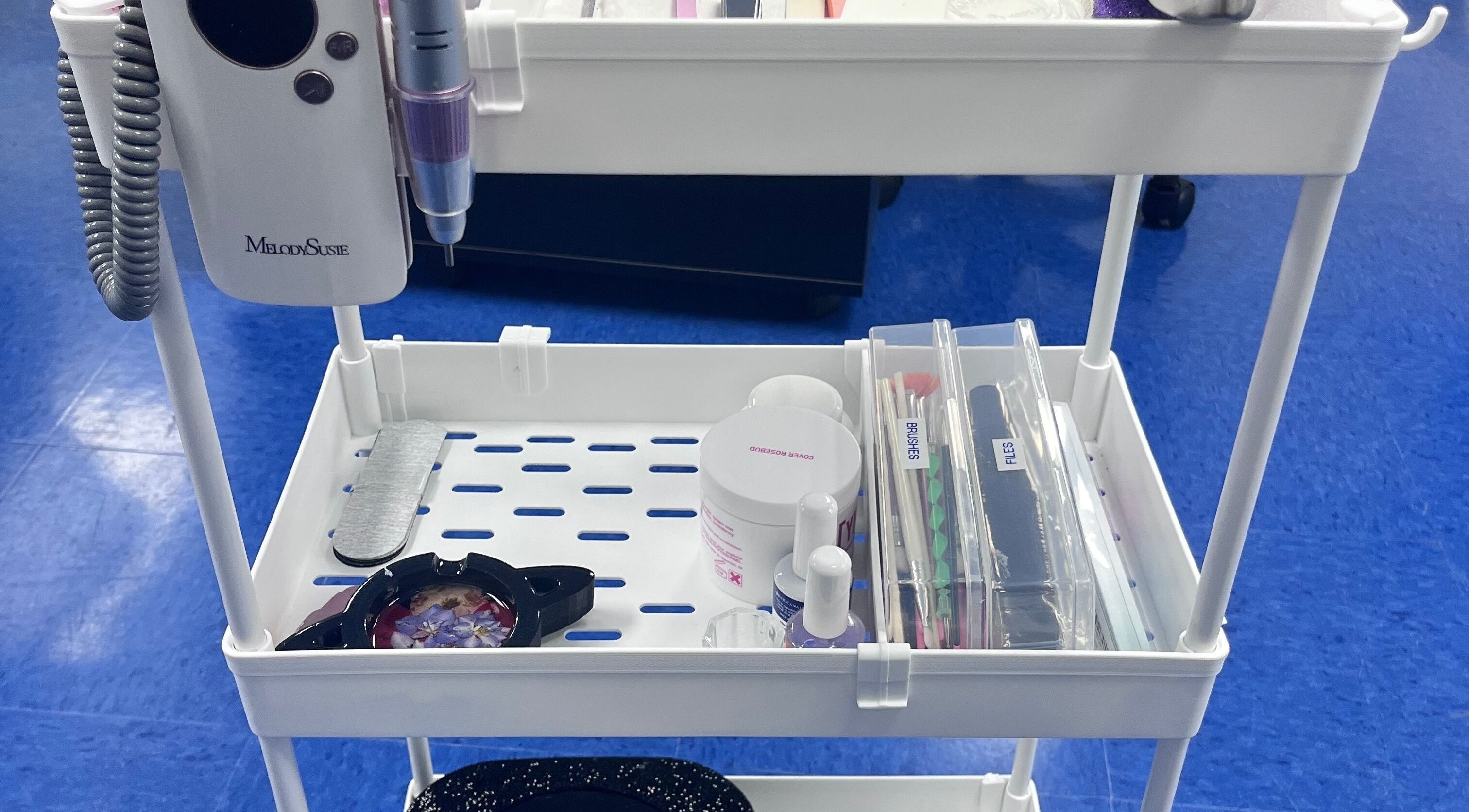 Nail tool station at NailsoDivine in Orlando, Florida, US, featuring polishes, files, and brushes.