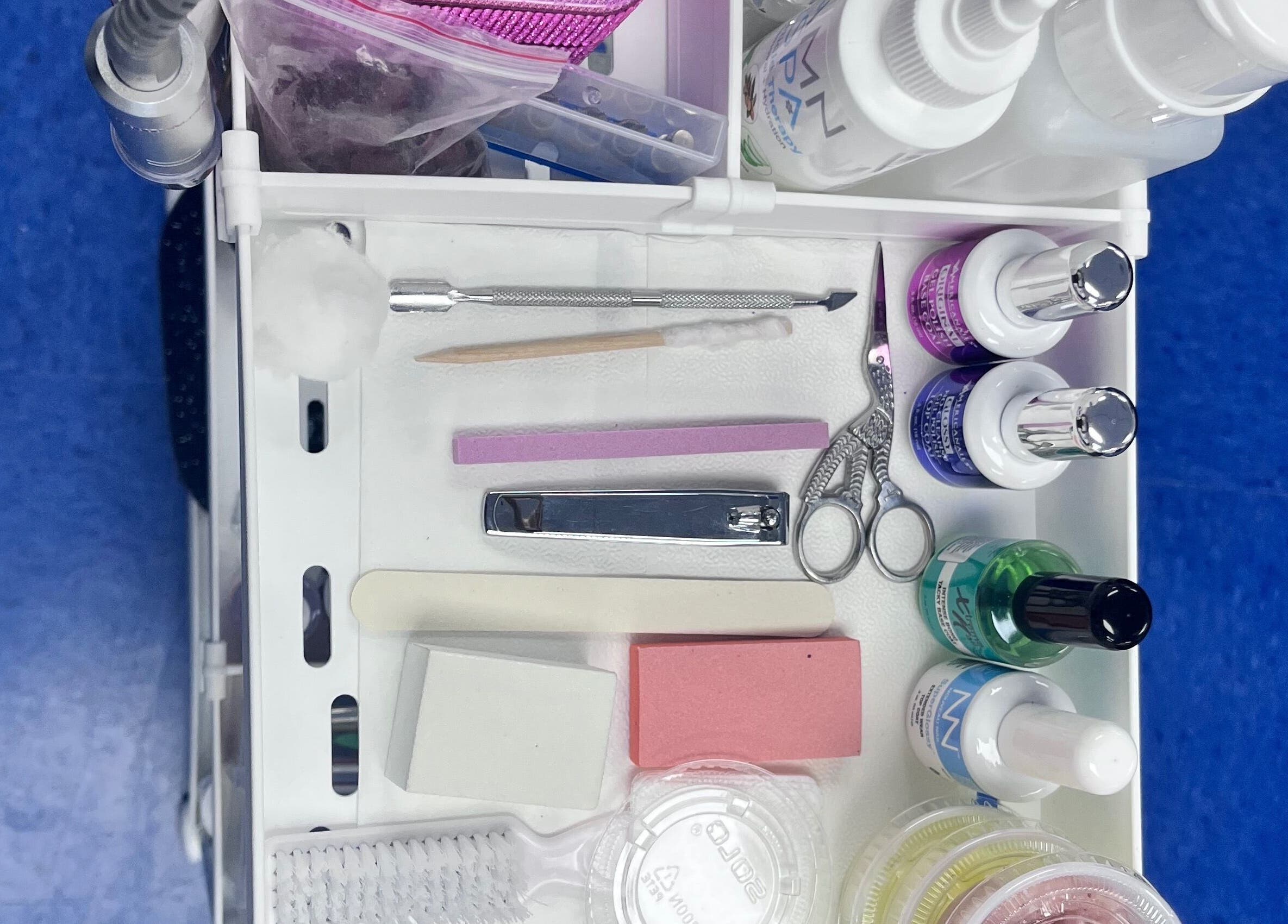 Nail tools and products neatly organized at NailsoDivine in Orlando, Florida, US for expert manicures.
