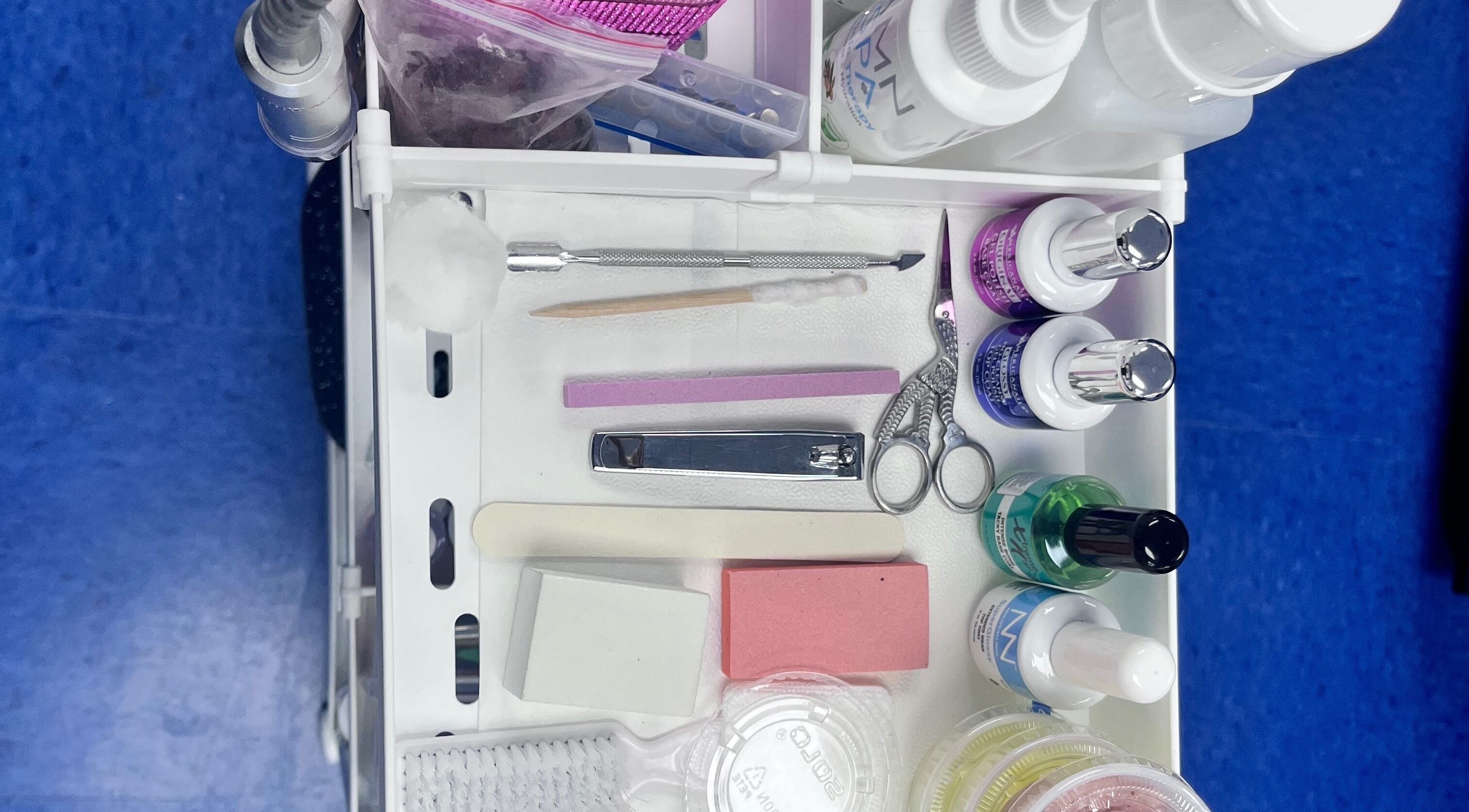 Nail tools and products neatly organized at NailsoDivine in Orlando, Florida, US for expert manicures.