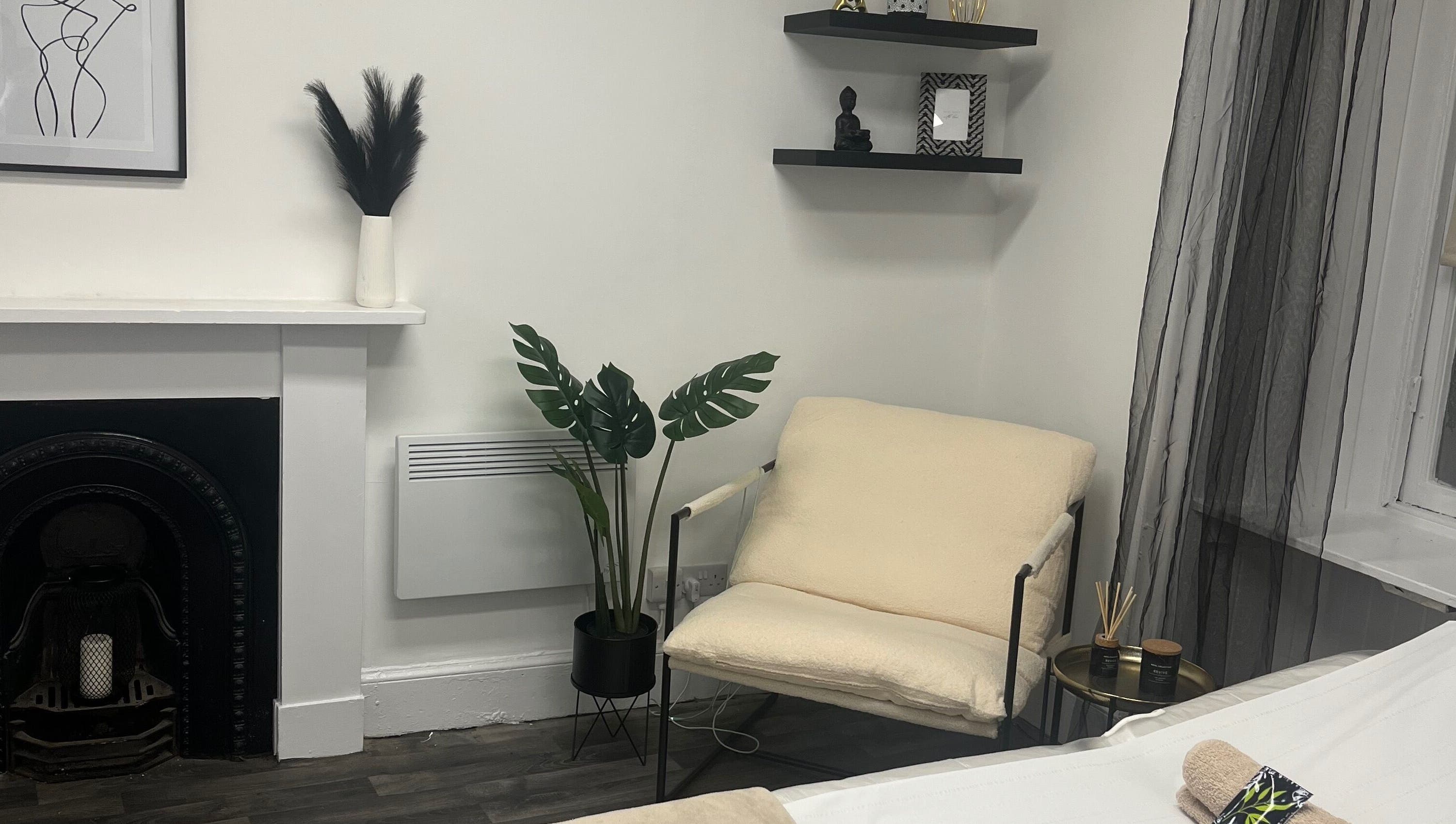 Calming space at Wylde Wax Studio in Glasgow, Scotland, GB with minimalist decor and a plush armchair.
