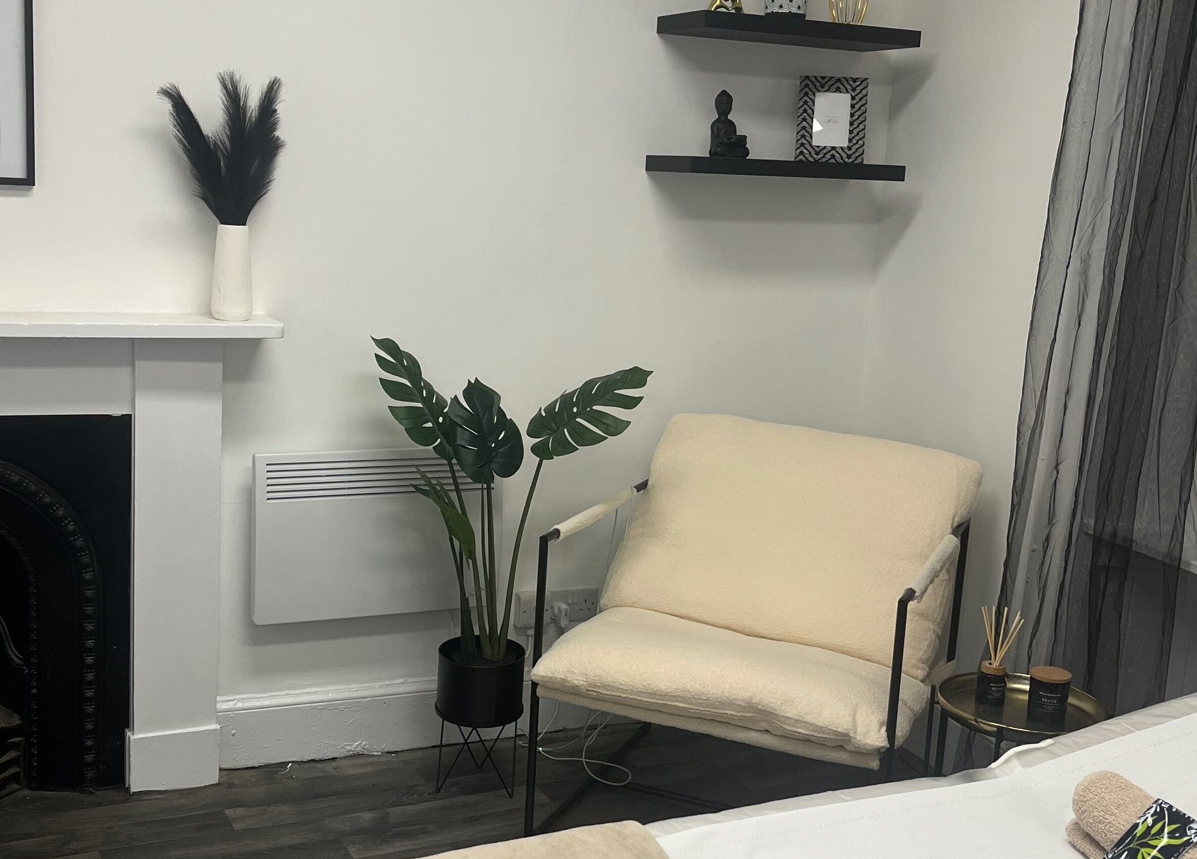 Calming space at Wylde Wax Studio in Glasgow, Scotland, GB with minimalist decor and a plush armchair.