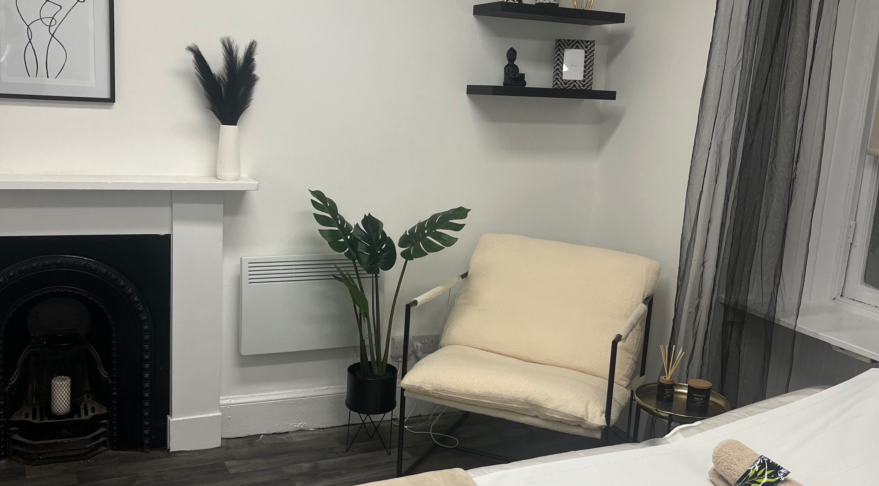 Calming space at Wylde Wax Studio in Glasgow, Scotland, GB with minimalist decor and a plush armchair.