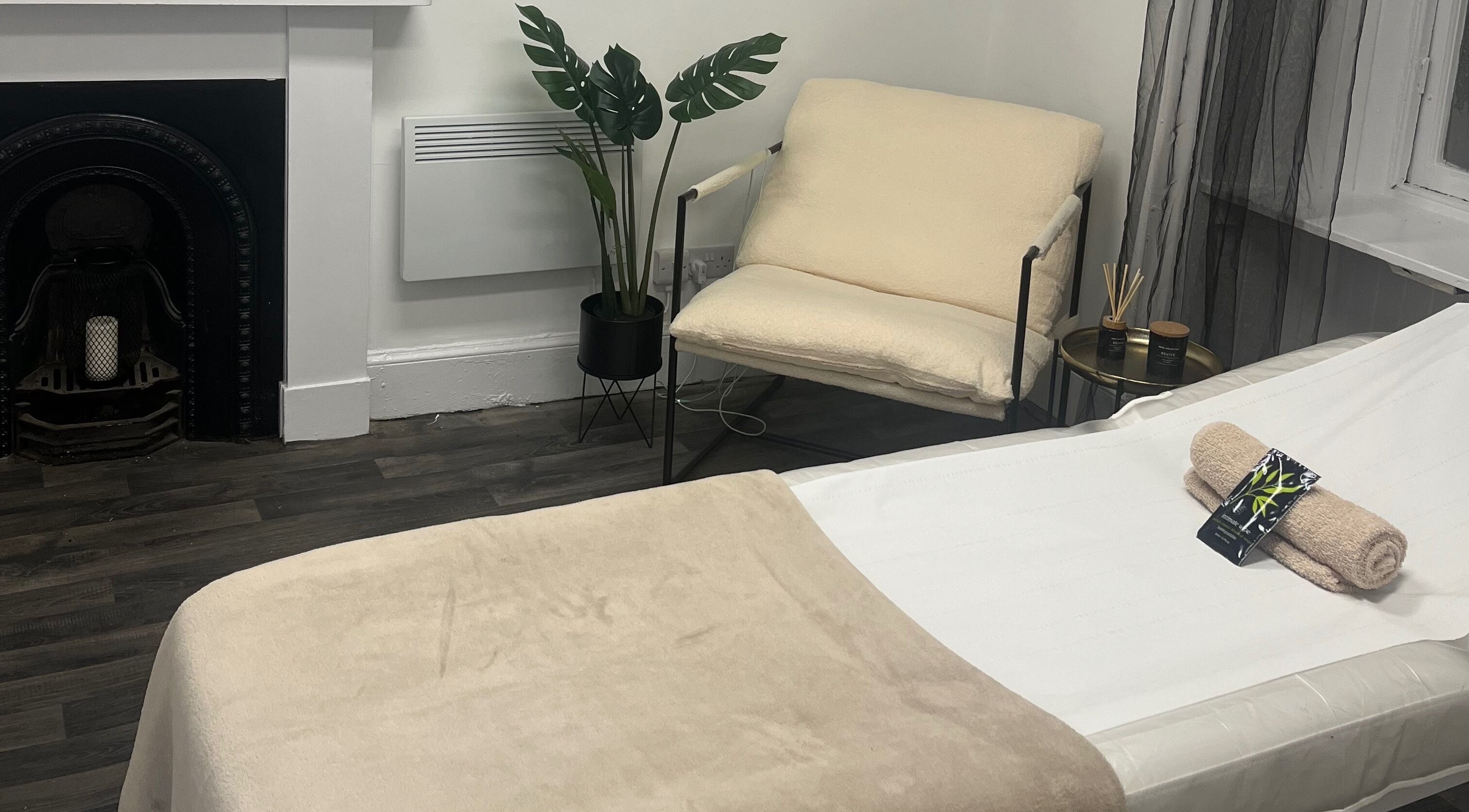 Relaxation space at Wylde Wax Studio, Glasgow, Scotland, GB with bed, chair, and decor.