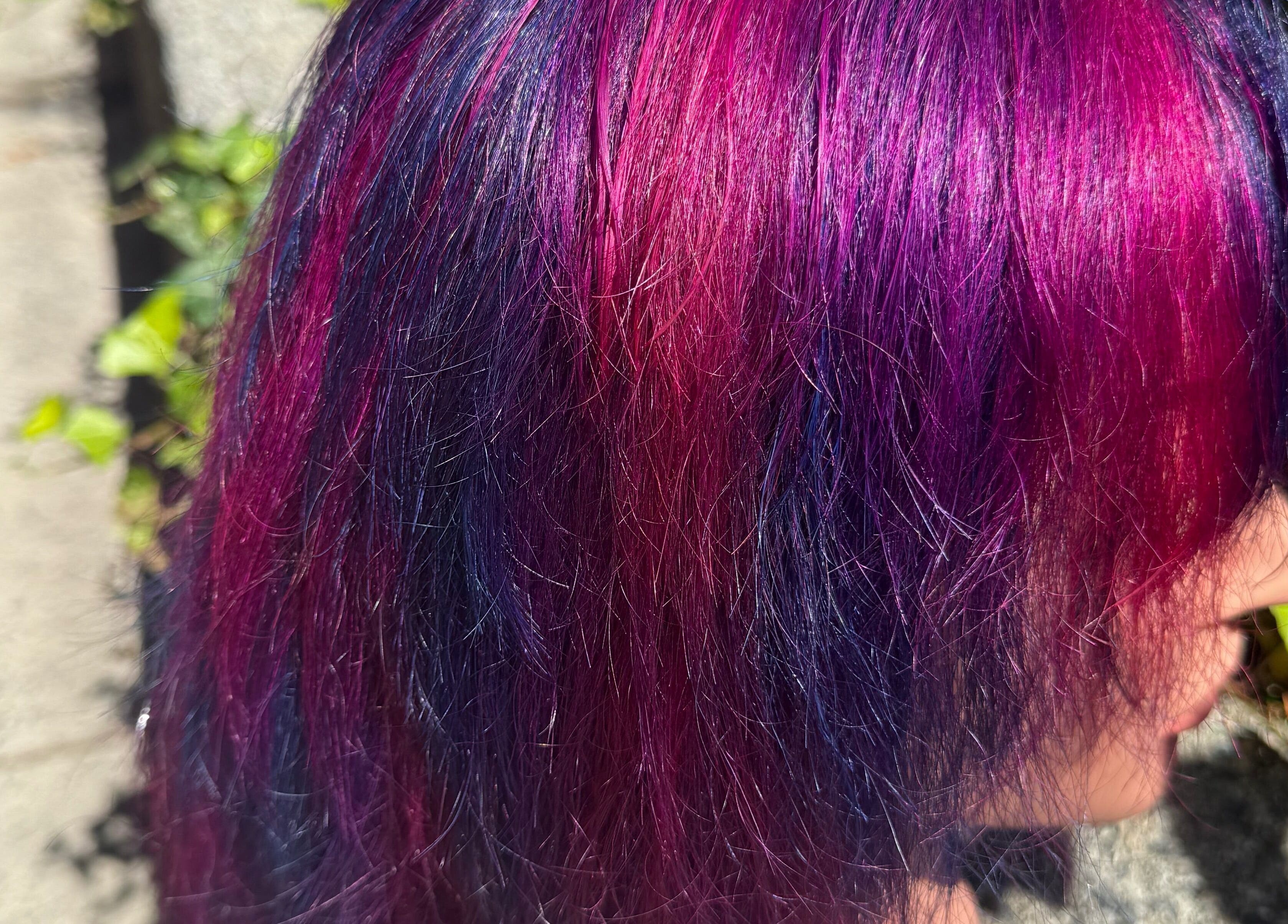 Bold pink and purple hairstyle at Hair_By_Taej in Abbotsford, British Columbia, CA under sunlight.