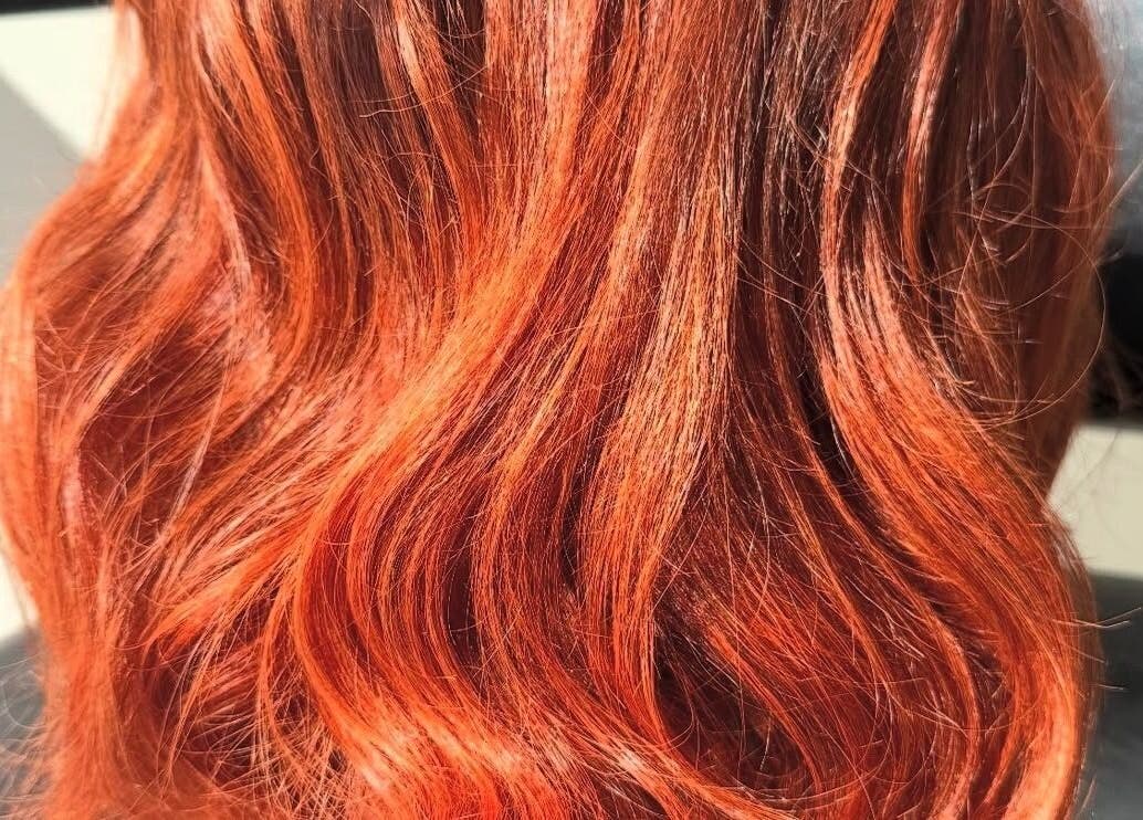 Vibrant red hair waves styled by Hair_By_Taej salon in Abbotsford, British Columbia, CA.