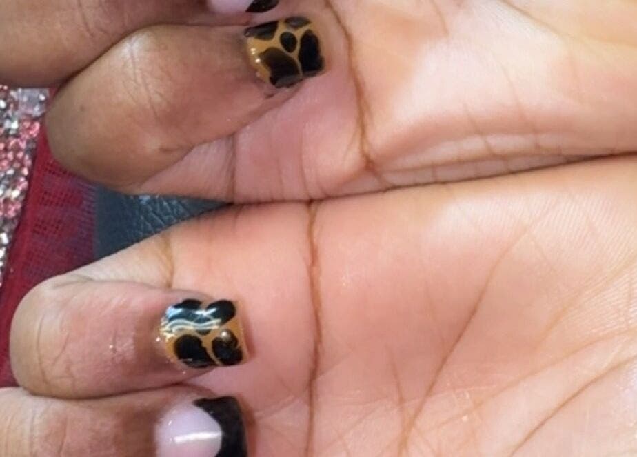 Stylish animal print manicure at PolishedByQ, Beltsville, Maryland, US, showcasing elegant nail art.