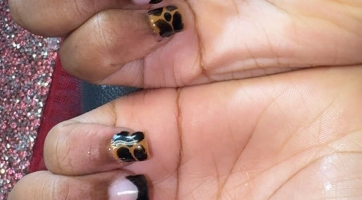 Stylish animal print manicure at PolishedByQ, Beltsville, Maryland, US, showcasing elegant nail art.
