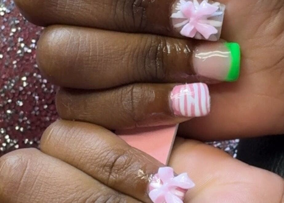 Creative nail designs at PolishedByQ in Beltsville, Maryland, US showcasing intricate 3D floral and striped art.