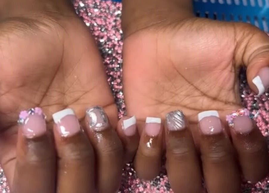 Elegant nail art with floral accents at PolishedByQ, Beltsville, Maryland, US, on a glitter background.