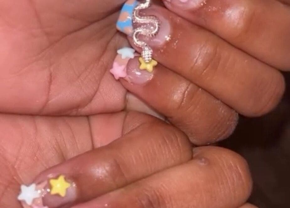 Close-up of starry nail art at PolishedByQ in Beltsville, Maryland, US, showcasing unique design.